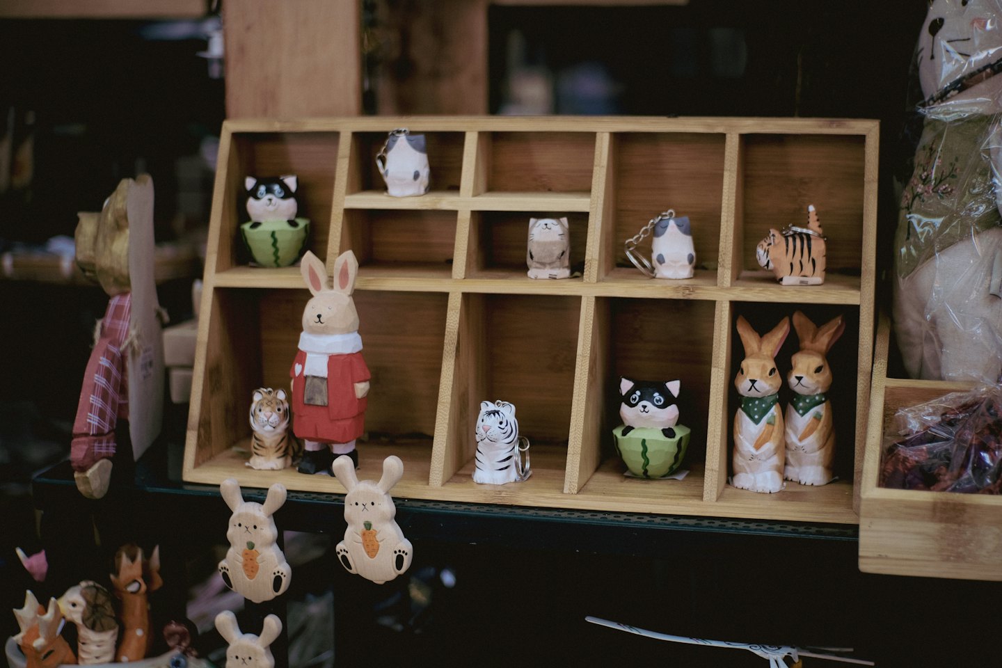 Hand-carved wooden animal figurines displayed on a store shelf.