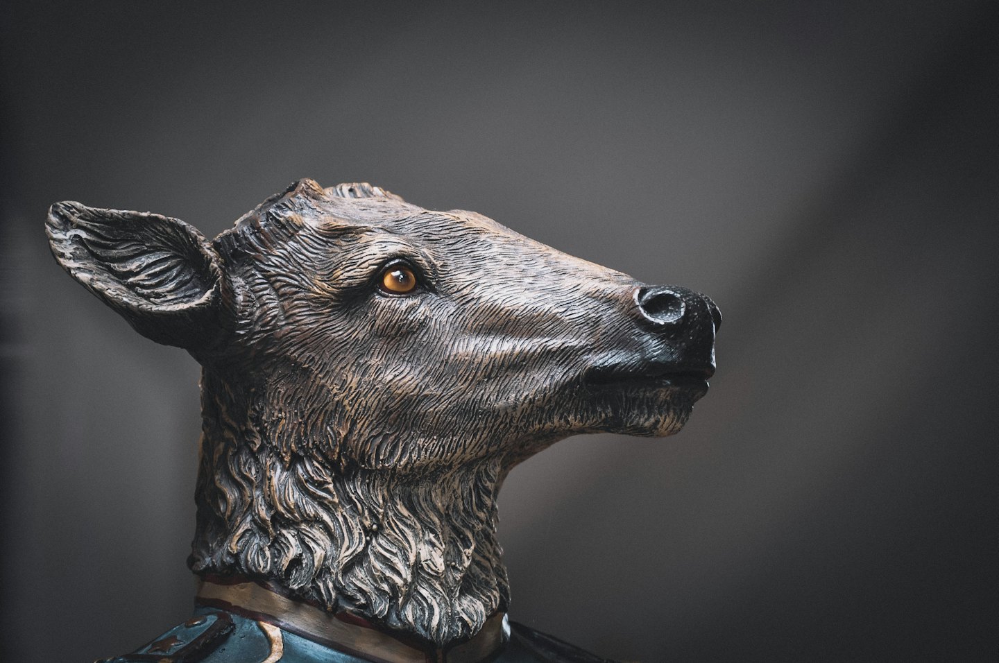 A detailed deer sculpture features fur texture and a decorative collar.